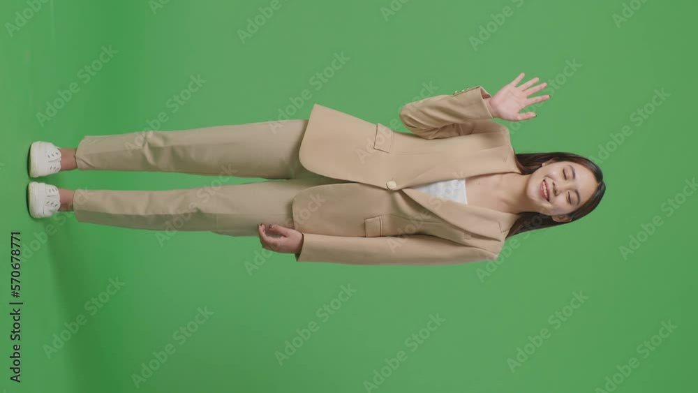 Full Body Of Asian Business Woman Waving Hand And Smiling While Standing On Green Screen In The Studio
Full Body Of Asian Business Woman Waving Hand And Smiling While Standing On Green Screen In The Studio