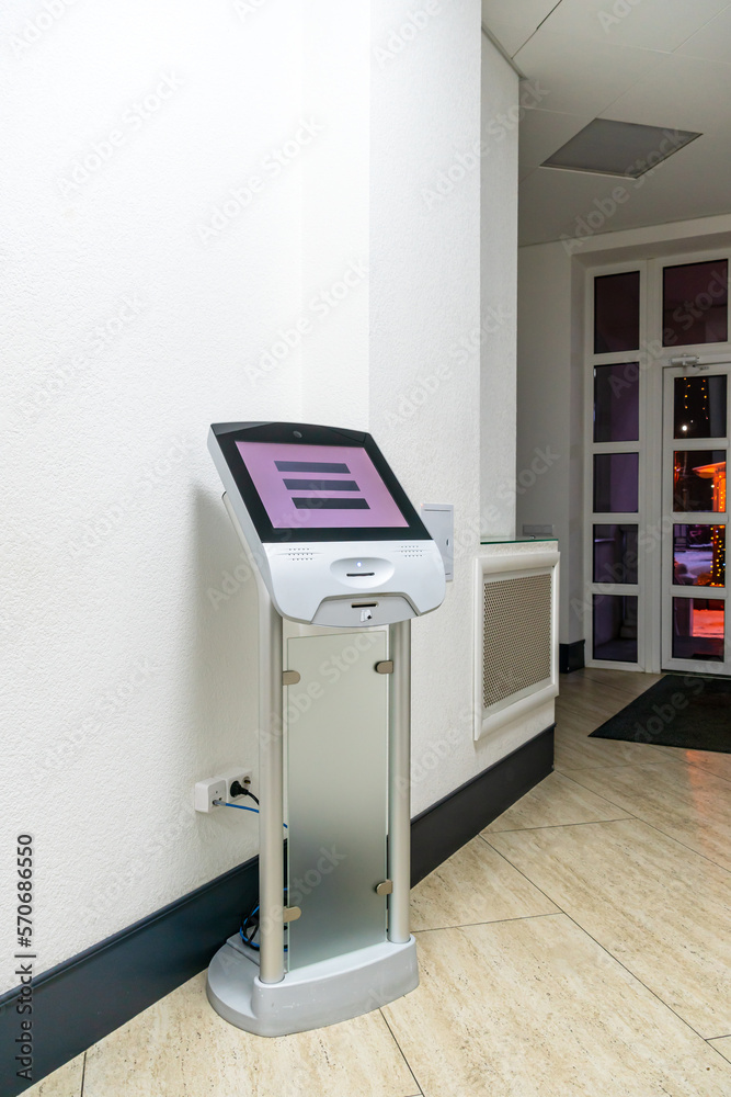 A modern touch screen terminal for customer service, an electronic queue in the service sector. Using a self-service kiosk or a terminal with a screen. A quick way to order food and buy tickets. A modern touch screen terminal for customer service, an electronic queue in the service sector. Using a self-service kiosk or a terminal with a screen. A quick way to order food and buy tickets.