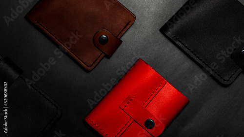 A set of handmade leather wallets. Multicolored. Leather craft. Men's wallets on a dark background. View from above.