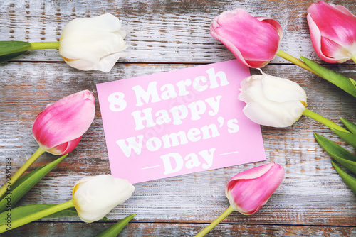Flowers of tulips and card with text 8 March Happy Women's Day on wooden background