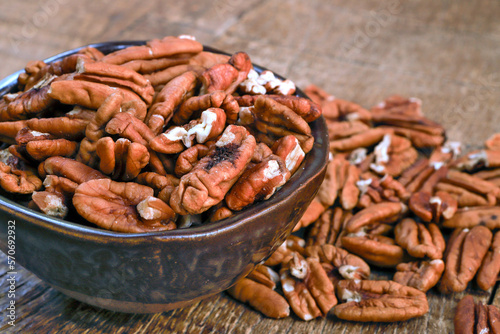 Bowl with pecan on rustic wooden table