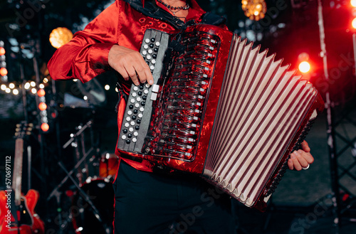 The musician plays the accordion. A hand plays the accordion close-up. Accordionist. Accordion.