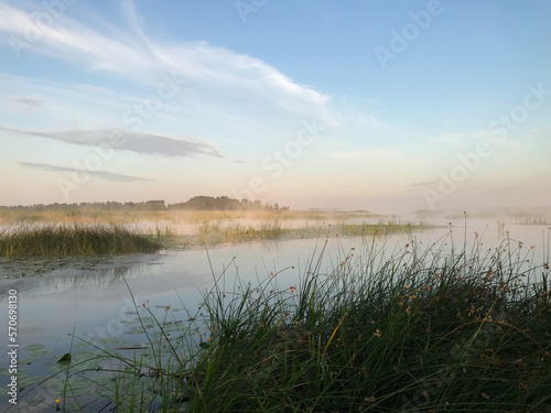 Summer, foggy landscape on the lake with blue sky with reflection of clouds in the lake. tourism and travel concept. high quality photo