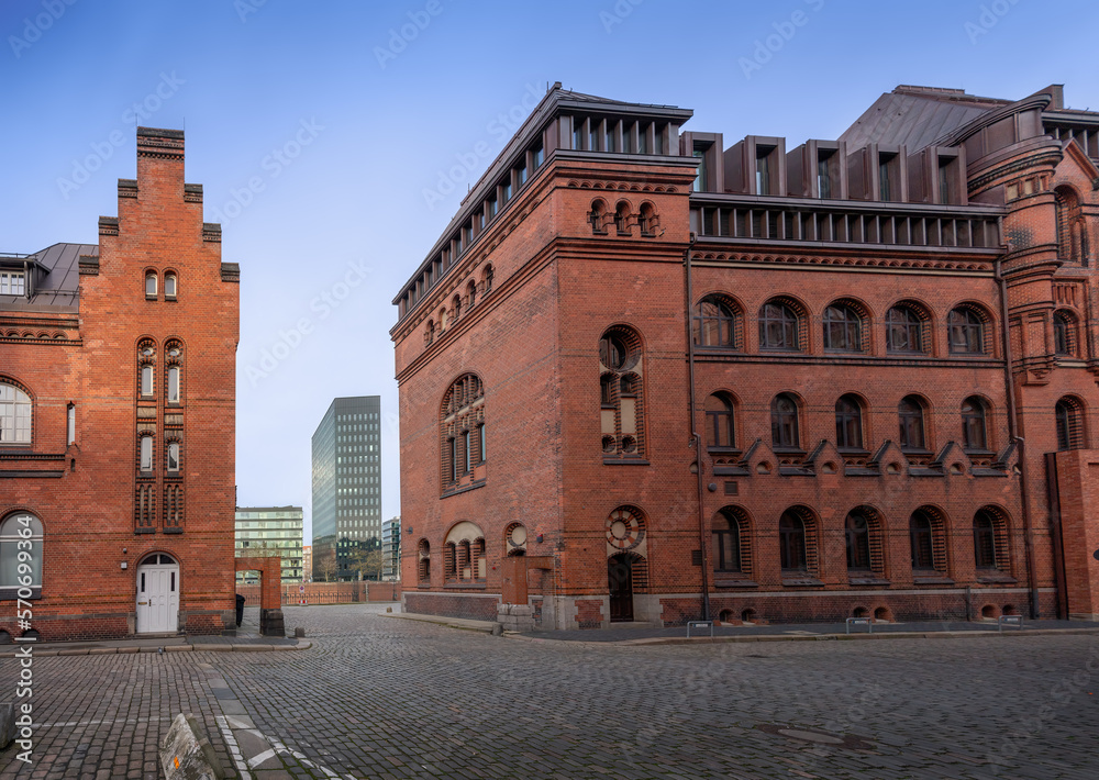 Brick buildings at Speicherstadt warehouse district with Modern Buildings of Dovenfleet on background - Hamburg, Germany