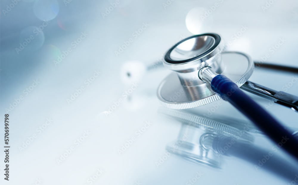 Stethoscope on glass table with reflection and copy space, monotone