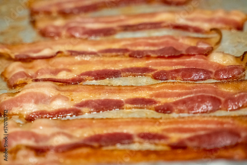 Close up view of bacon on a baking sheet