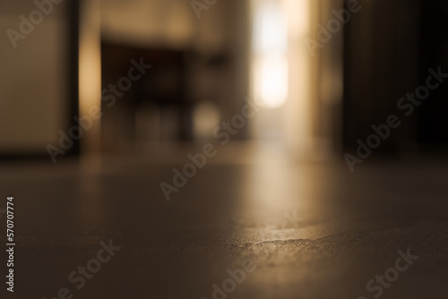 Dark indoor background with closeup focus on concrete floor