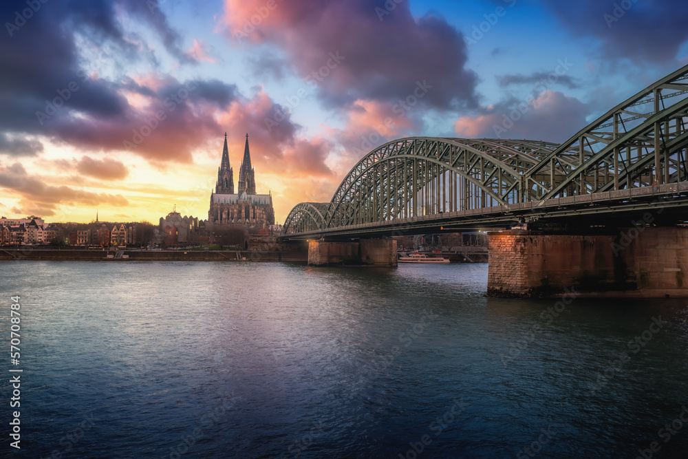 Cologne Skyline with Cathedral and Hohenzollern Bridge at sunset - Cologne, Germany
