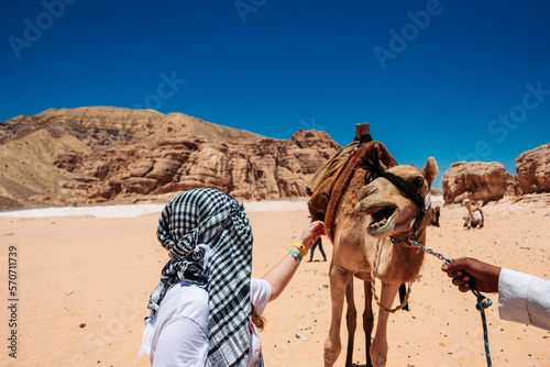 girl petting camel in the desert of egypt © Arlington Vance
