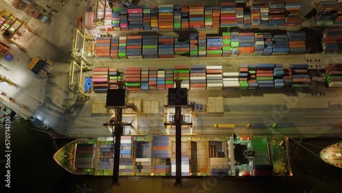 Hyperlapse timelap Aerial top view container cargo ship in import export business commercial trade logistic and transportation, many rows and stacks of container and big container loader ship vessel photo