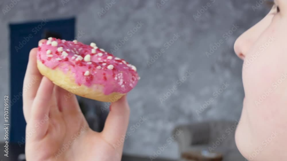 Delicious donut with icing in a child's hand. Delicious donut with icing in a child's hand.