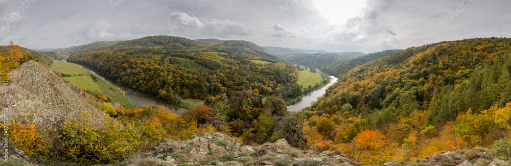 Autumn day on the rocks above the Berounka river valley - gray clouds with the sun shining through