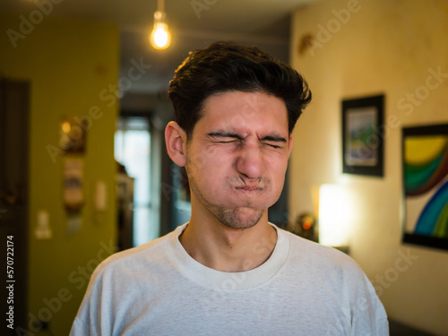 Young man with puffed cheeks, holding breath