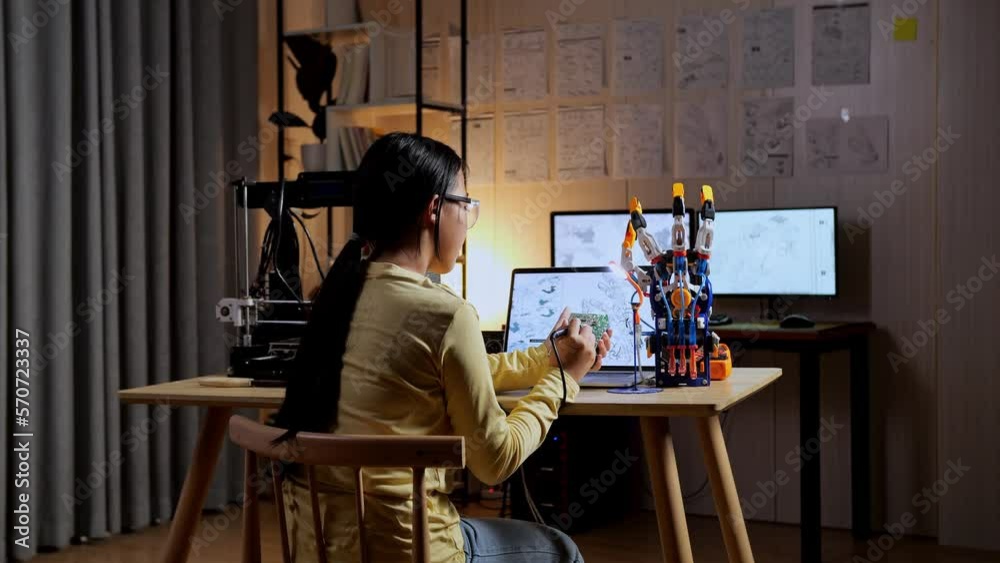 Back View Of Teen Asian Girl Holding And Fixing The Circuit Board While Repairing A Cyborg Hand At Home
Back View Of Teen Asian Girl Holding And Fixing The Circuit Board While Repairing A Cyborg Hand At Home