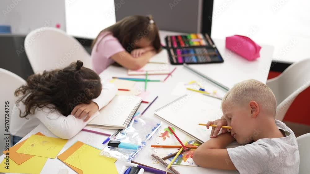 Group of kids students sitting on table sleeping at classroom Group of kids students sitting on table sleeping at classroom