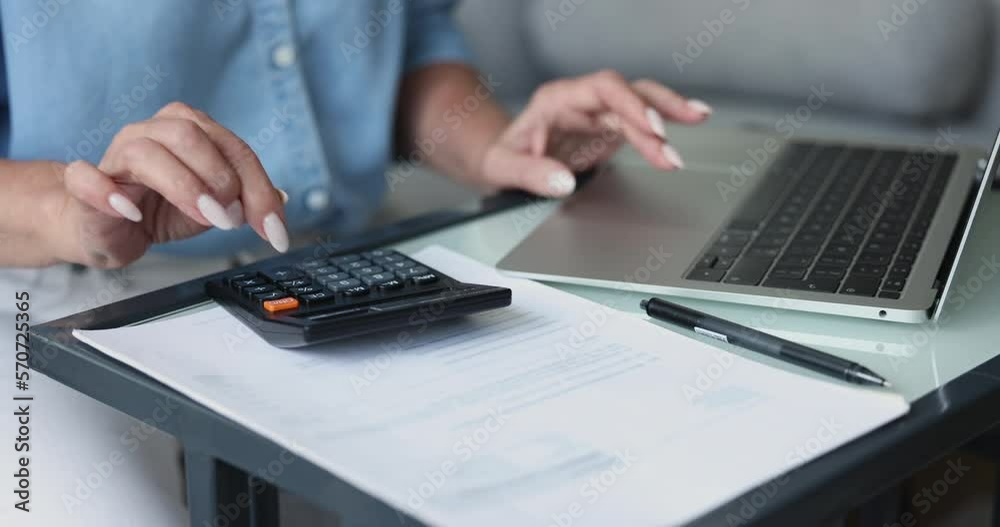 Close up of unknown woman do accountancy, bookkeeping work using laptop, reviewing and paying for utilities, makes payment using e-bank app on laptop, typing on computer, planning expenses and incomes Close up of unknown woman do accountancy, bookkeeping work using laptop, reviewing and paying for utilities, makes payment using e-bank app on laptop, typing on computer, planning expenses and incomes