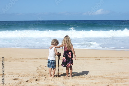 sisters embrace on the beach