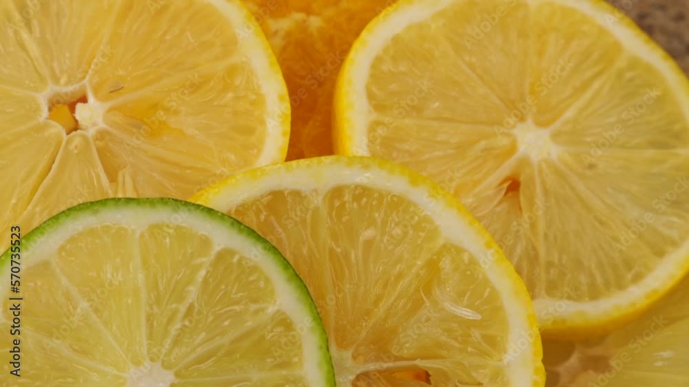 Cooking citrus lemonade. Falling lime slices on lemon and orange slices. Slow motion. Cooking citrus lemonade. Falling lime slices on lemon and orange slices. Slow motion.