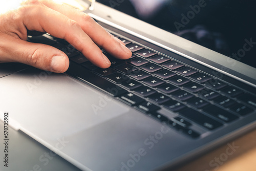 Work On Laptop Pc. Close up image of hands typing text or programming code using the computer at home.
Businessman working on laptop on the table.
