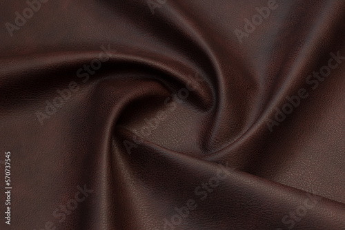 brown artificial leather with waves and folds on PVC base