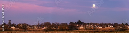 The rising moon at sunset over marshes, Topsham, Devon, England, Europe photo