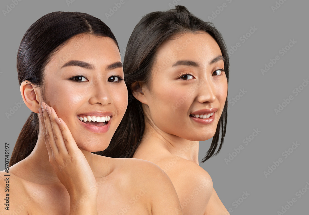 Beautiful chinese half-naked ladies posing on grey, copy space