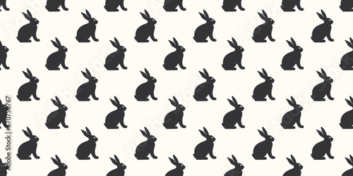 Hand drawn seamless pattern with cute doodle silhouette bunnies. Easter background. Perfect for textile or paper wrapping design. Vector illustration
