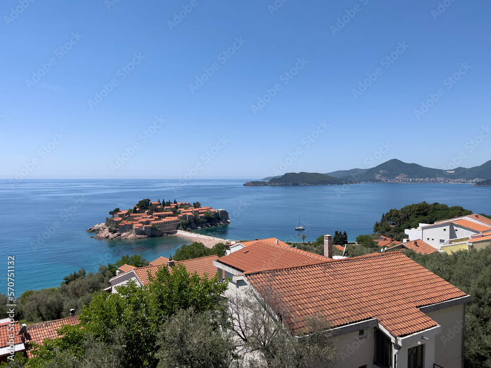 View over the red roofs of coastal houses on the island of Sveti Stefan. Montenegro