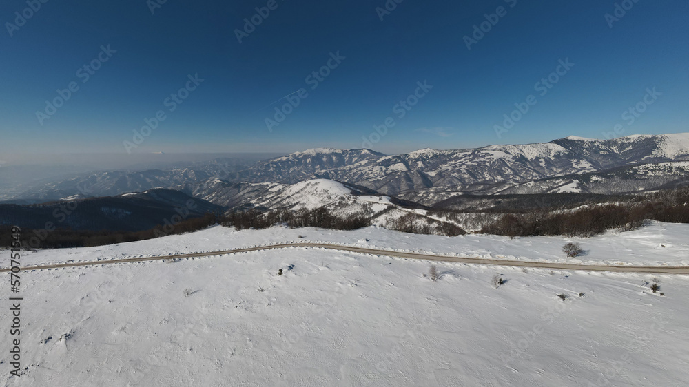 Stara Planina Babin Zub mountain in serbia covered with snow with road in winter day panorama tourist destination and ski center in Serbia road against the mountain peak