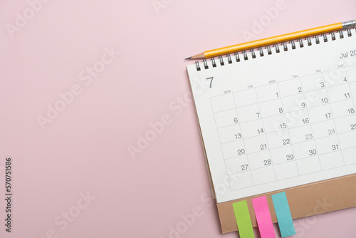 close up of calendar and pencil on the pink table background, planning for business meeting or travel planning concept