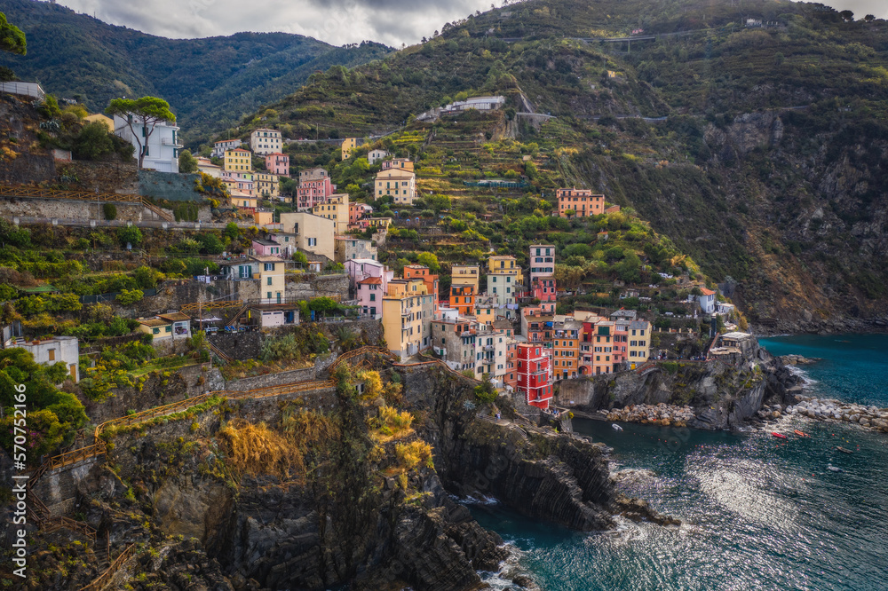 Riomaggiore, Italy - September 2022: The colorful fishing village of Riomaggiore, Italy, one of the five Cinque Terre Villages along the Ligurian Sea. Aerial drone shot