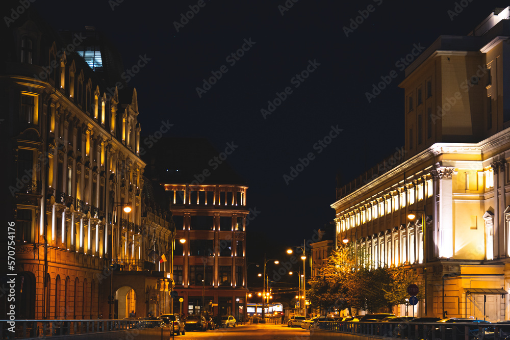 Night photo of Wroclaw old town, city center and many old houses brightly lit by yellow lanterns
