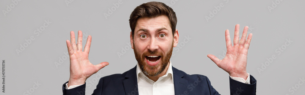 Emotional male business coach in suit puts his hands up and screams Emotional male business coach in suit puts his hands up and screams