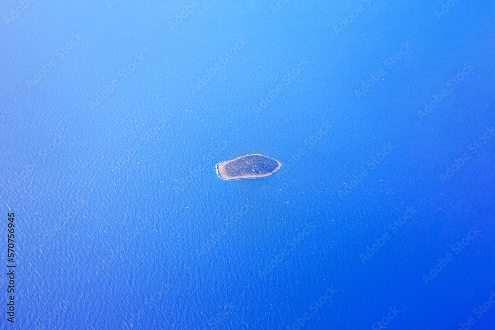 Island in blue sea water aerial view . Desert island in the ocean Island in blue sea water aerial view . Desert island in the ocean