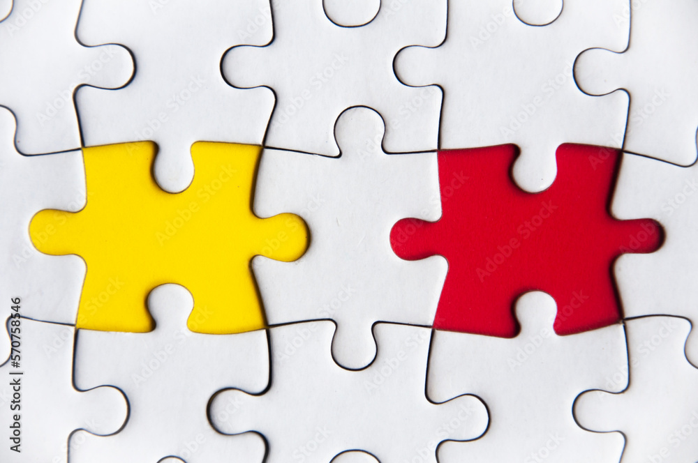 Missing jigsaw puzzle in red and yellow color with customizable space for text or ideas. Copy space. Missing jigsaw puzzle in red and yellow color with customizable space for text or ideas. Copy space.