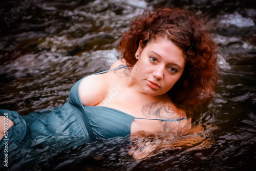 Beautiful curly haired woman in the water, sexy