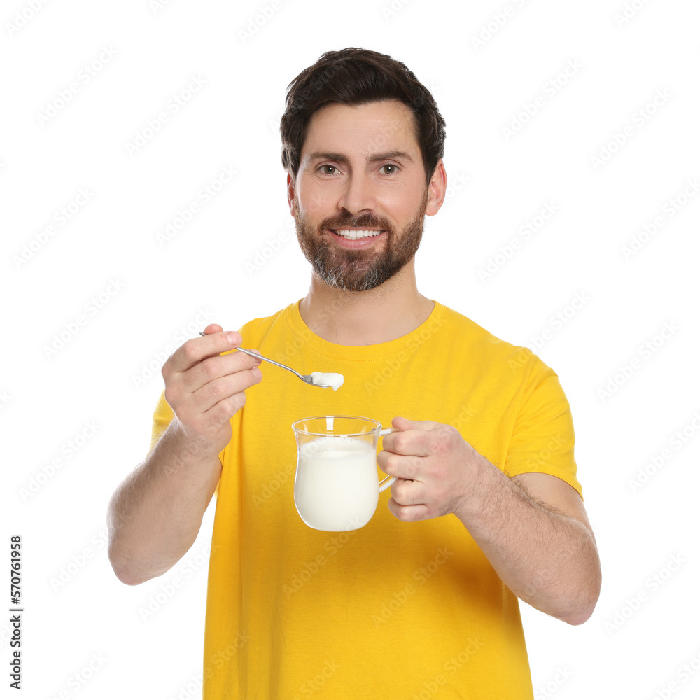 Handsome man with delicious yogurt and spoon on white background Handsome man with delicious yogurt and spoon on white background