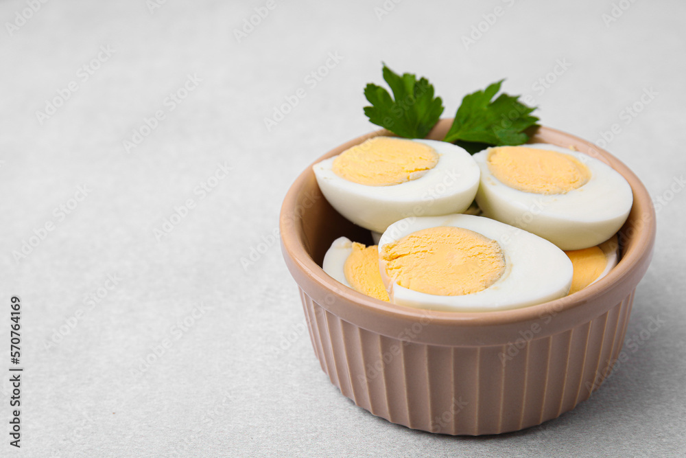 Fresh hard boiled eggs and parsley on light grey table. Space for text Fresh hard boiled eggs and parsley on light grey table. Space for text