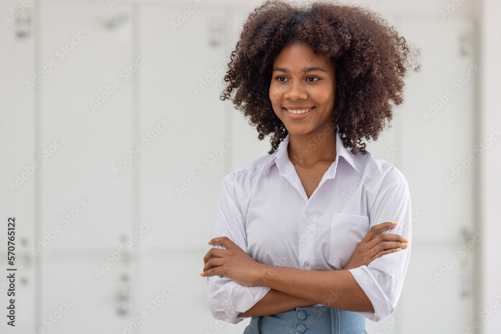 Female african american business woman in at the workplace, standing confidently. Attractive young businesswoman with a happy smile. Female african american business woman in at the workplace, standing confidently. Attractive young businesswoman with a happy smile.