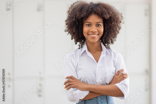Female african american business woman in at the workplace, standing confidently. Attractive young businesswoman with a happy smile.