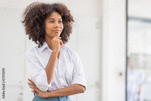 Female african american business woman in at the workplace, standing confidently. Attractive young businesswoman with a happy smile. 