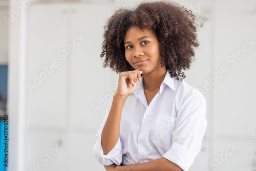 Female african american business woman in at the workplace, standing confidently. Attractive young businesswoman with a happy smile. 