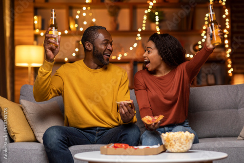 Fotografiet Emotional black lovers celebrating beginning of weekend at home