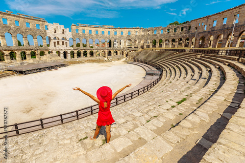 Tourist girl visiting the Coliseum of Pula, located in Istria, Croatia, can view a well-maintained Roman amphitheater. This structure was created by the Roman Empire between 27 BC and 68 AD.