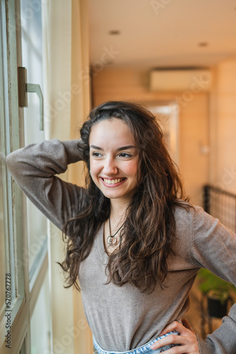 A portrait of a young girl by the windows smiling Free Download A portrait of a young girl by the windows smiling - GFXLoad