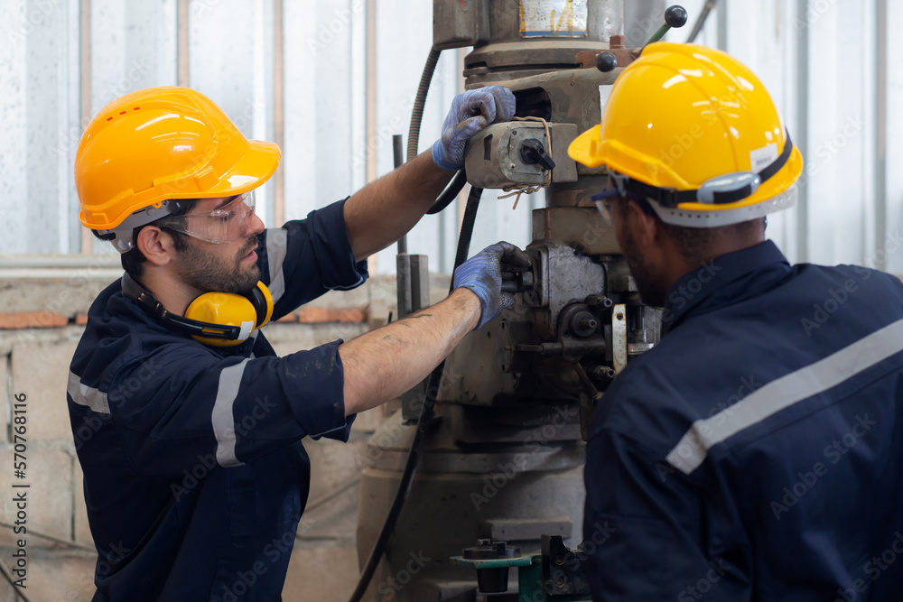 Engineer man training with foreman for apprentice using lathe, apprenticeship teaching with worker, technician and learning, inspector and labor, internship and workshop, industrial concept. Engineer man training with foreman for apprentice using lathe, apprenticeship teaching with worker, technician and learning, inspector and labor, internship and workshop, industrial concept.
