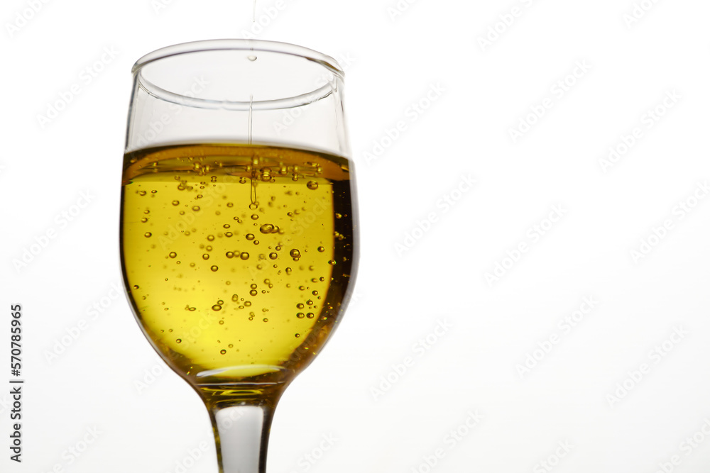 glass cup with extra virgin olive oil with bubbles