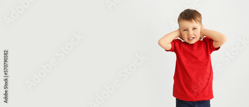 Stressed little boy with au...