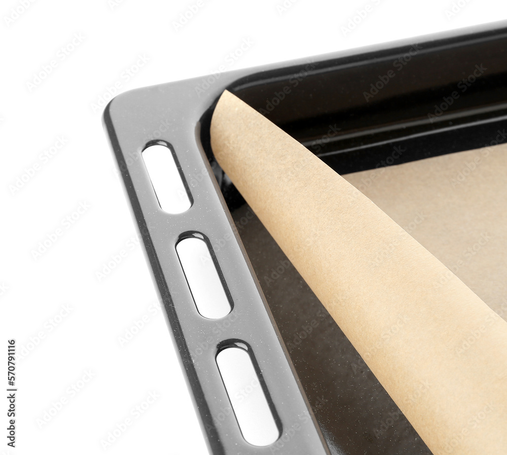 Baking sheet with paper on white background, closeup Baking sheet with paper on white background, closeup