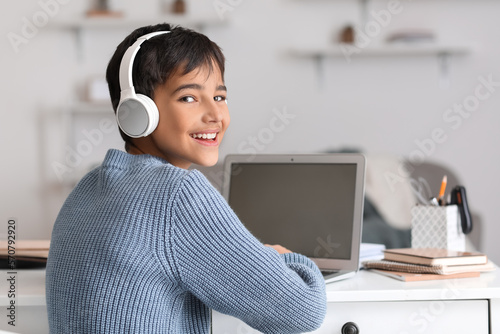 Little boy in headphones us...